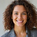 A vibrant and energetic portrait of a woman with a friendly smile, symbolizing a Head of Customer Experience.