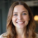 A professional and friendly portrait of a woman with warm eyes, symbolizing a co-founder.